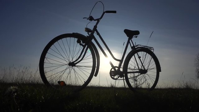 A bike in a meadow against a background of blue sky