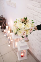 Man holds bride's white bouquet