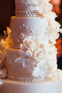 Rich layered wedding cake decorated with white flowers