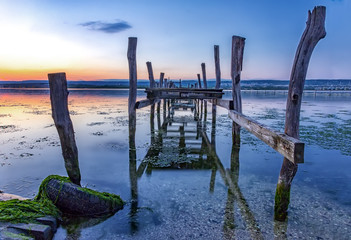 Old broken wooden pier in blue hour
