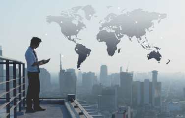 Fototapeta premium Businessman use smartphone on rooftop of building with technology effect, globalization conceptual