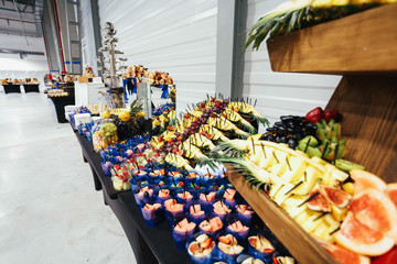 Rich served dishes with different fruits and stand on the table