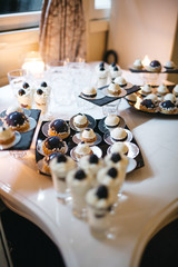 Delicious desserts made in white and black colors served on a candy bar
