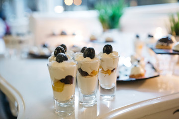 Delicious desserts made in white and black colors served on a candy bar