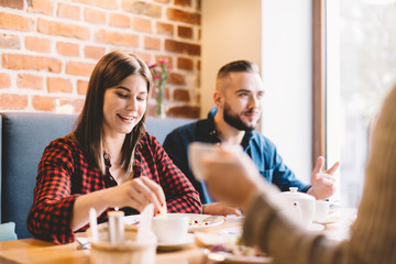 Happy couple sitting in a restaurant, eating
