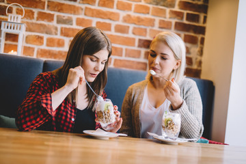 Women eating healthy dessert in a restaurant.