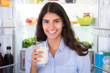 Young Woman Holding Glass Of Milk