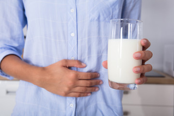 Mid Section View Of A Woman Holding Glass Of Milk