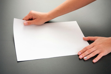 Female hands with paper on a black background. studio isolate.