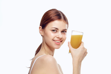 Young beautiful woman on white isolated background holds a glass of freshly squeezed juice, diet, fitness