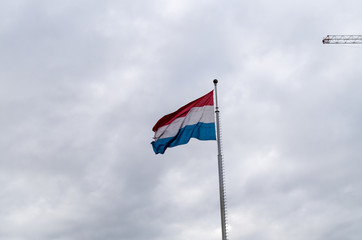Low Angle View of Luxembourgian Flag against Sky on a Windy Day in Autumn in Luxembourg City, Luxembourg