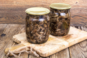 Fototapeta na wymiar Home made cans. Glass jars with pickled mushrooms