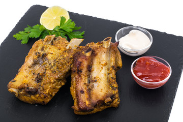 Pork ribs on black stone plate