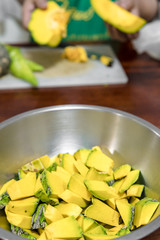 Pumpkin was cut into pieces and put it in a cup. To prepare for it cooking. Pumpkin vegetables are useful and vitamins are good for the body.