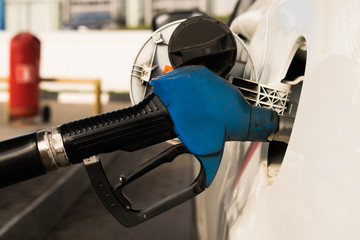 refueling gun in the gas tank of the car