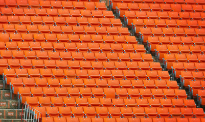 Contemporary stadium with orange seats arrange in rows