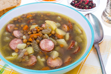 Dish from lentils, vegetables and sausages