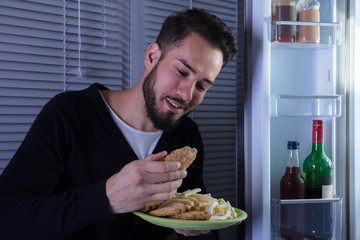 Young Man Eating Fried Food