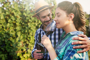 People tasting wine in vineyard