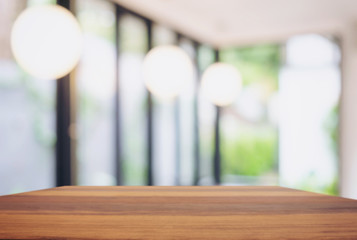 Empty wooden table and blurred background of abstract in front of restaurant or coffee shop for display of product or for montage