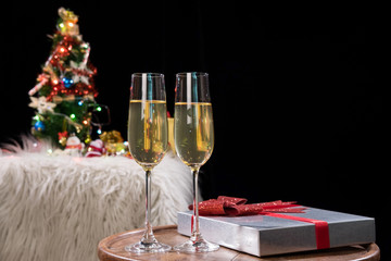 Happy Relaxing at party, Two champagne glasses and sparkle, Christmas tree ornament on the background