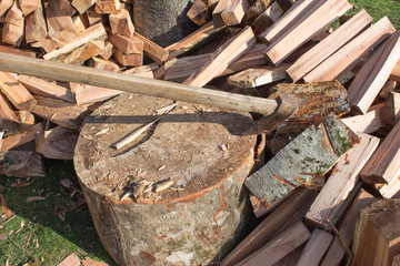 Axe stuck in a stump. Device for chopping trees. Preparing firewood. Chopping wood for fuel