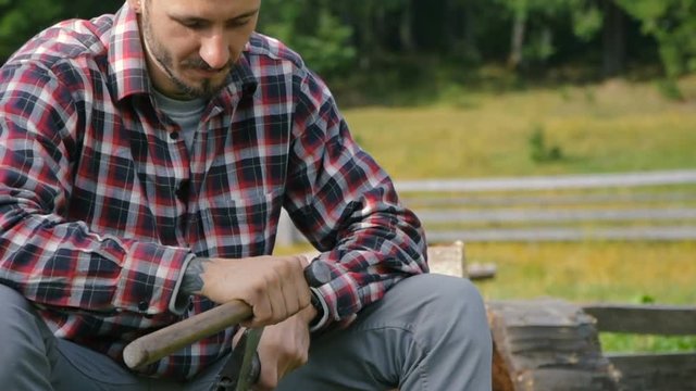 man sharpening an axe