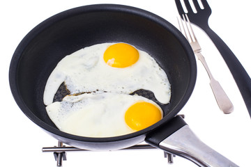 Two fried eggs on Teflon frying pan