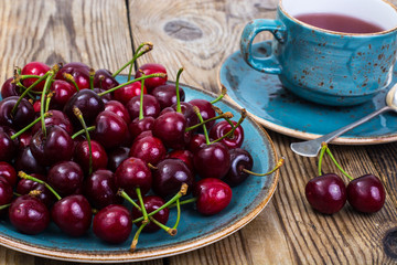 Cherry compote and fresh cherry on plate