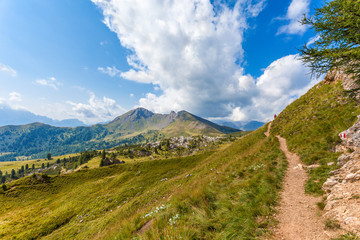 Man walking towards volcanic Mount Col di Lana, Valparola Pass, Dolomites, Italy