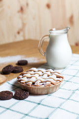 American Pie, jug with milk and cookies on a light wooden table and towel