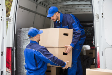 Two Movers Carrying Cardboard Box