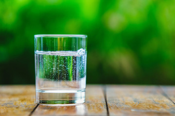 A glass of water on green background