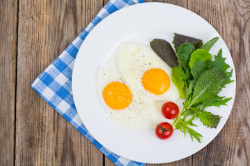 Breakfast. Fresh salad leaves and two fried eggs
