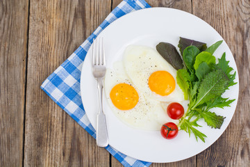 Breakfast. Fresh salad leaves and two fried eggs