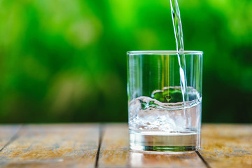 A glass of water on green background