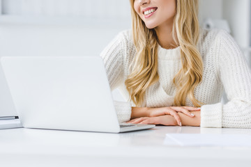 smiling businesswoman working with laptop