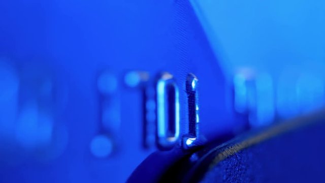 Payment by the credit card. Сredit card in the payment terminal. Extreme closeup. Shallow depth of field.
