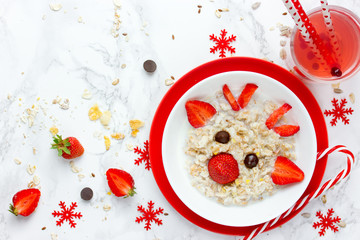 Fun Christmas breakfast idea for kids oatmeal bowl with fruit in the form of Christmas reindeer