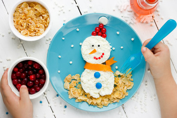 Child eating  cottage cheese snowman