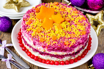 Russian layered salad with beet, potato, carrot, egg, pickled herring and mayonnaise for Christmas dinner