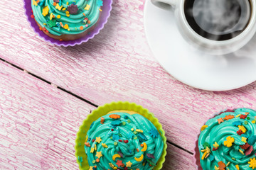 cakes cupcakes to the celebration of Christmas on the wooden table, and a Cup of hot coffee