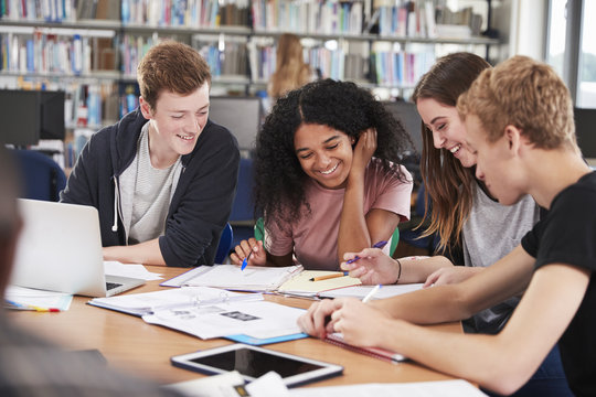 Group Of College Students Collaborating On Project In Library - Powered by Adobe