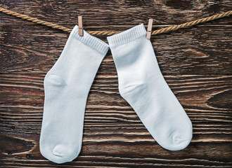 white socks hanging and drying on the clothesline