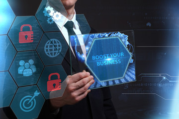 Business, Technology, Internet and network concept. Young businessman working on a virtual screen of the future and sees the inscription: Boost your business