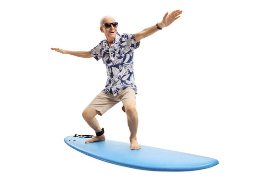 Joyful elderly man surfing