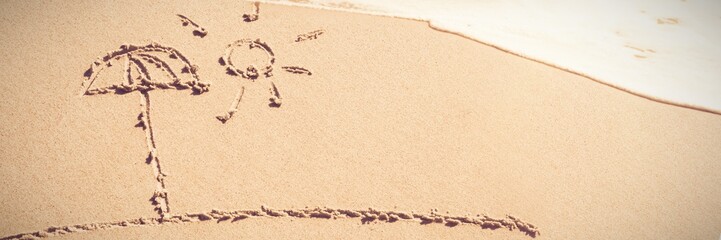 Fototapeta na wymiar Sun and umbrella drawn on sand