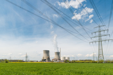Nuclear power plant with green field and high voltage electric wire in Germany. Europe.
