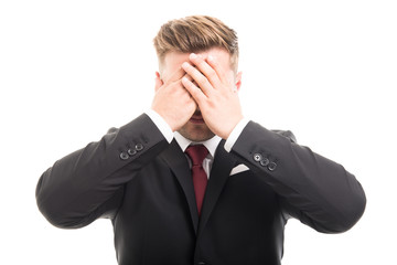 Handsome business man covering eyes like blind gesture