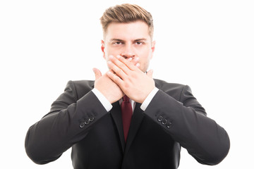 Handsome business man covering mouth like mute gesture
